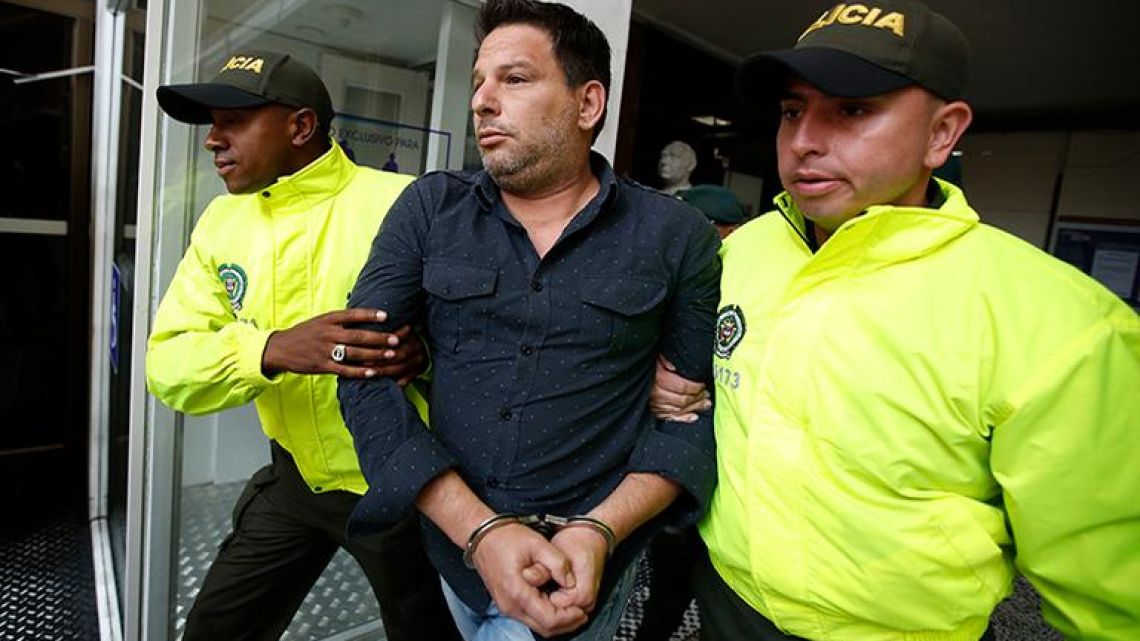 Police escort Cuban suspect Raul Gutierrez to court where a judge will rule on prosecutors’ request he be held on terrorism and conspiracy charges in Bogota, Colombia.