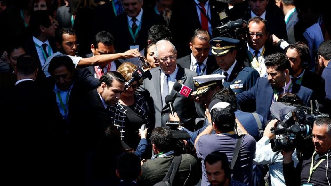 Peru's President Pedro Pablo Kuczynski (centre) leaves the Congress in Valparaíso, Chile, after attending the swearing-in ceremony of Chilean new President Sebastian Piñera (out of frame), on March 11, 2018.