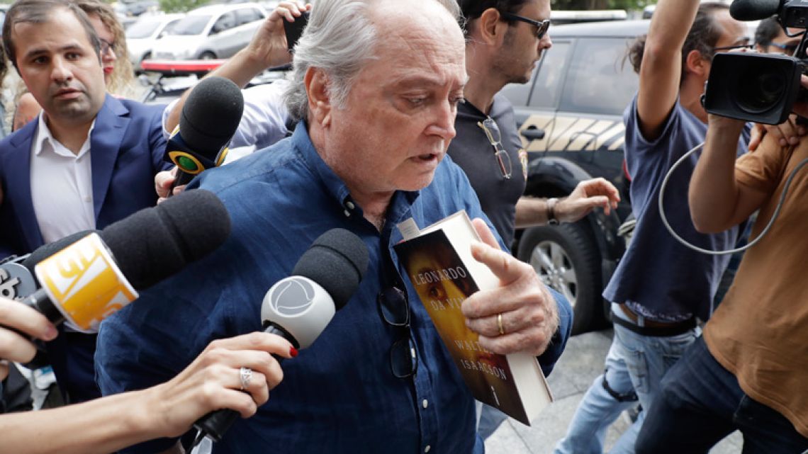 Police escort detainee Wagner Rossi, Brazil's former Agriculture Minister, into Federal Police headquarters, in São Paulo. Rossi has been arrested in connection to an investigation into whether President Michel Temer accepted bribes for favours to a company operating at the country's largest port.