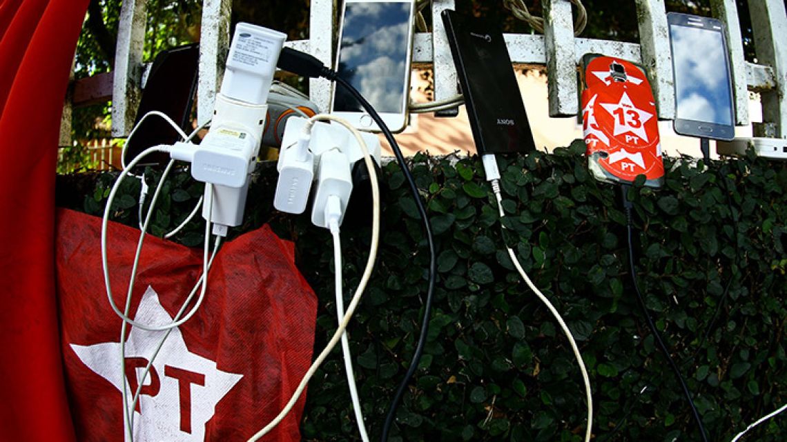 Mobile phones of supporters of Brazilian former president Luiz Inácio Lula da Silva camping in the surroundings of the Federal Police headquarters where the ex-president is serving a 12-year prison sentence for corruption, are charged in Curitiba, Brazil.