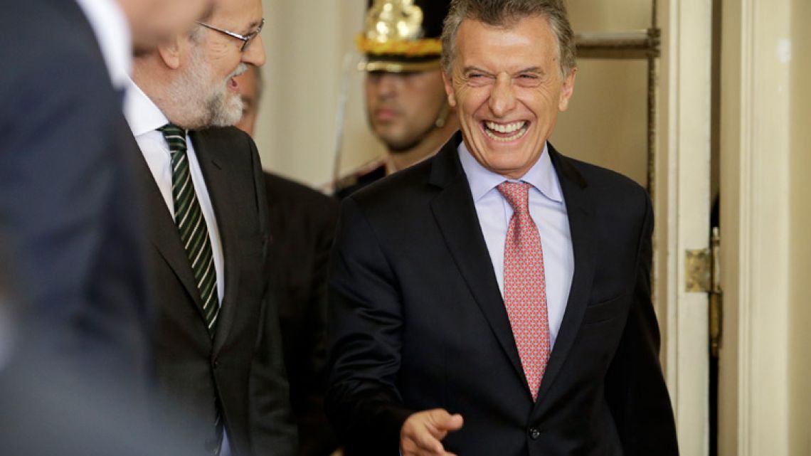 President Mauricio Macri, right, laughs with Spain's Prime Minister Mariano Rajoy, left, as they arrive for a joint press conference at the Casa Rosada earlier today.