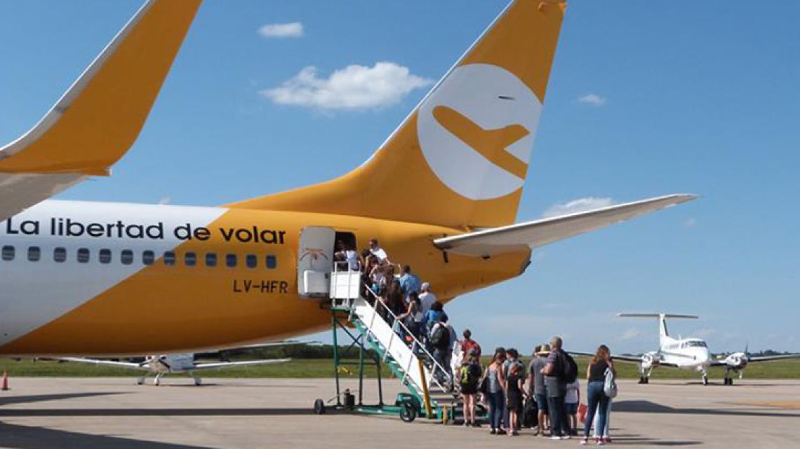FlyBondi passengers queue to board a flight departing El Palomar Airport in Greater Buenos Aires.