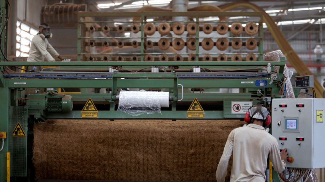 Employees of Frysk Industrial, a subsidiary of the Brazilian-American group Aurantiaca, work at the coconut industrial facility near Conde, a city about 200 km north of Salvador.