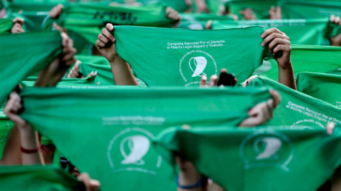 Demonstrators in front of Congress wearing the green handkerchiefs that symbolise the abortion rights movement.
