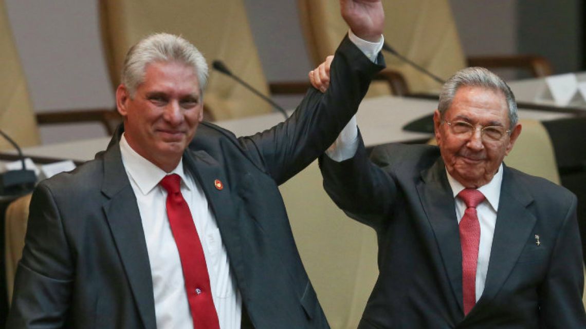Handout picture shows outgoing Cuban president Raúl Castro (right) raising the arm of new President Miguel Díaz-Canel after he was formally named president by the National Assembly, in Havana.