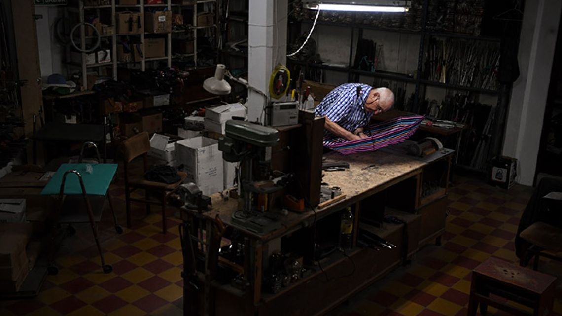 Umbrella fixer Elias Fernández, 87, works fixing umbrellas at his workshop in Buenos Aires.