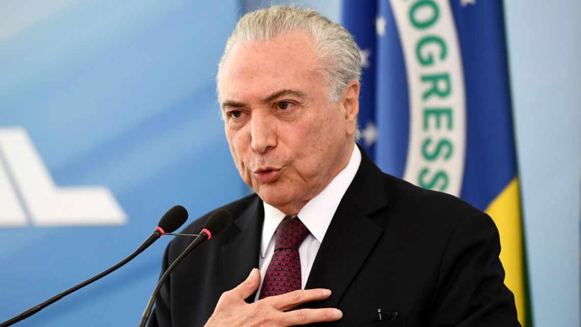 Brazilian President Michel Temer delivers a statement to defend himself and his family from allegations of corruption, at the Planalto Palace in Brasilia.