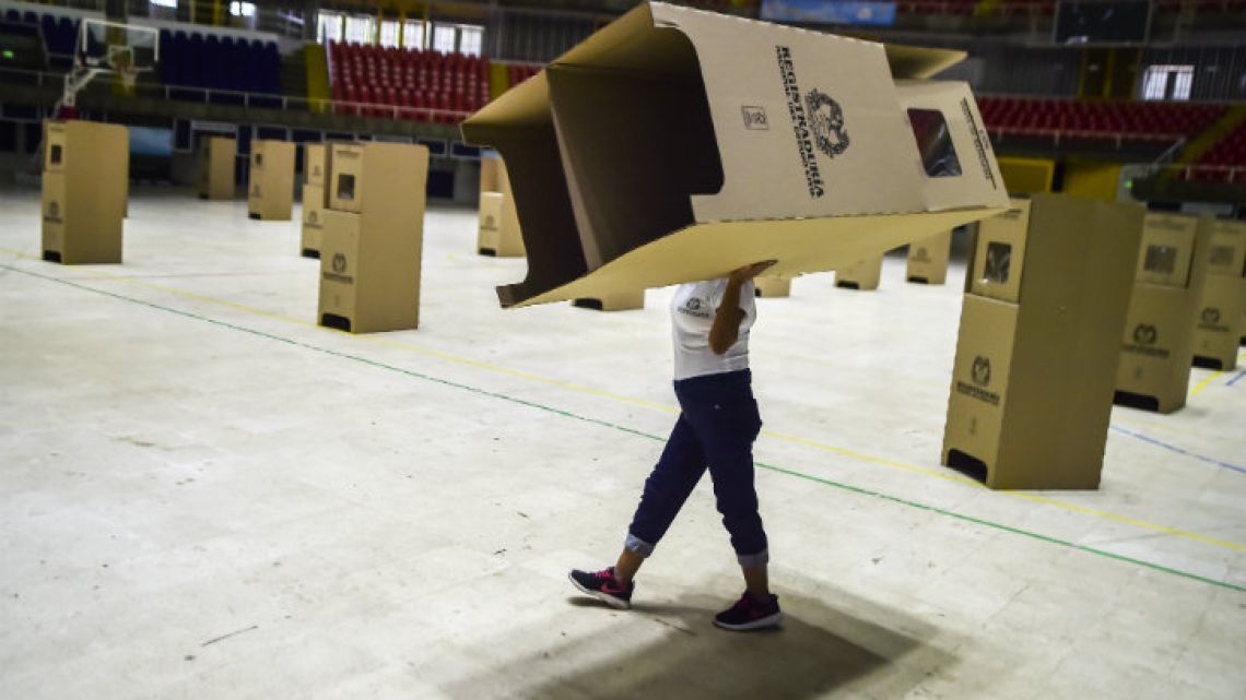 A worker assembles voting booths at a polling station in Cali, Colombia.