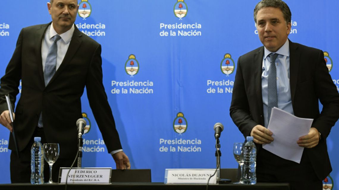 Central Bank Governor Federico Sturzenegger (left) and Finance Minister Nicolás Dujovne arrives for a press conference in Buenos Aires announcing the details of the deal with the IMF.