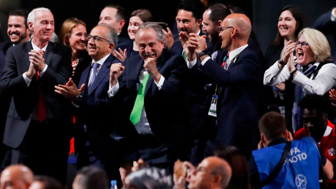 Delegates of Canada, Mexico and the United States celebrate after winning a joint bid to host the 2026 World Cup at the FIFA Congress in Moscow, Russia, Wednesday, June 13, 2018.