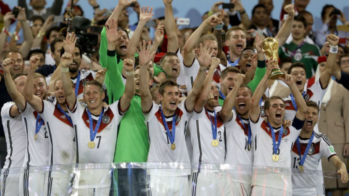 Germany’s Philipp Lahm holds up the World Cup trophy in 2014.