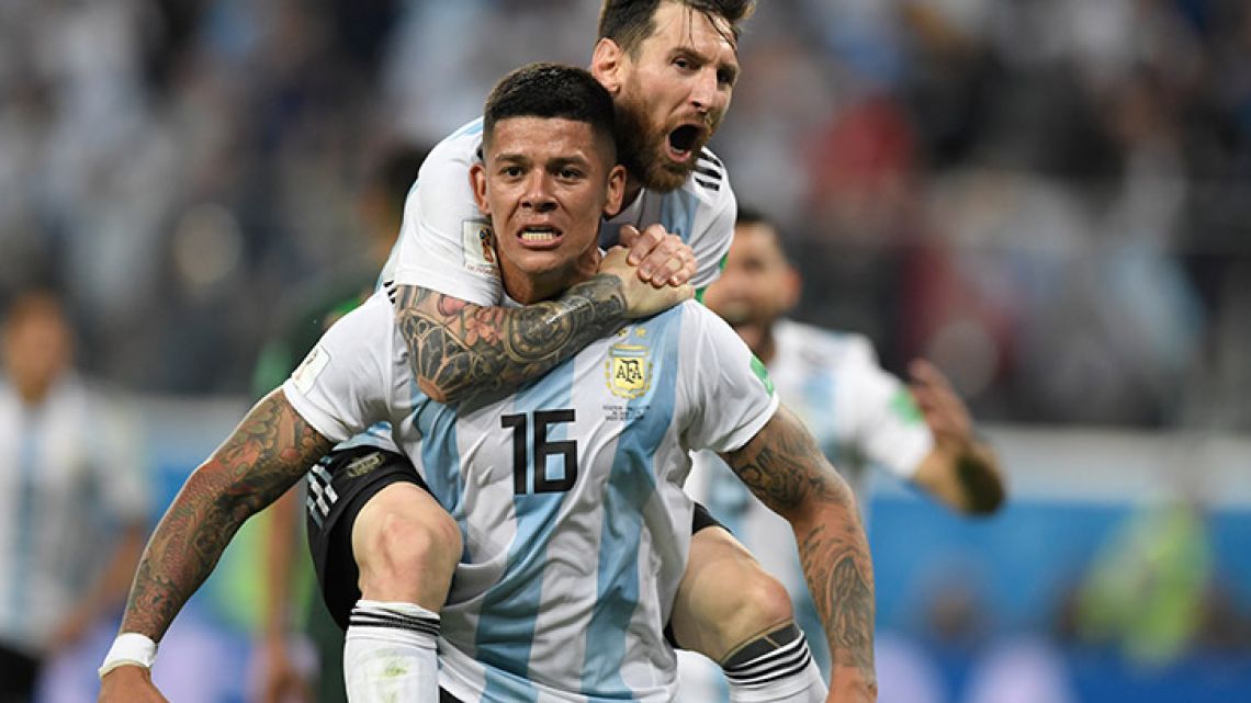 Marcos Rojo and Lionel Messi celebrate after the Manchester United defender volleyed home Argentina's second goal in their clash with Nigeria in St Petersburg