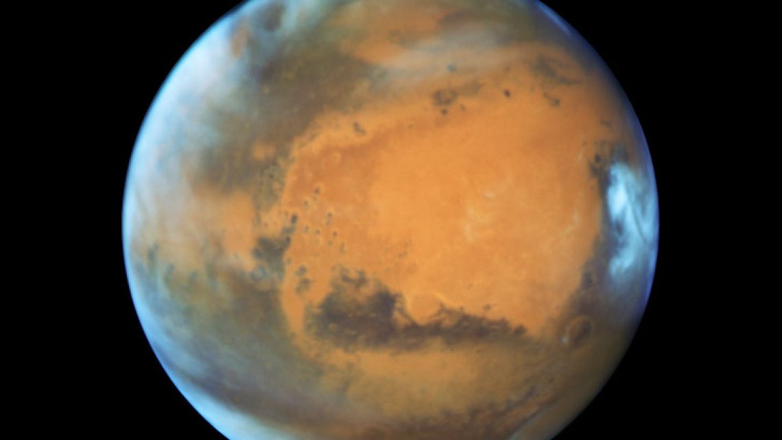 This May 12, 2016 image provided by NASA shows the planet Mars. A study published Wednesday, July 25, 2018 in the journal Science suggests a huge lake of salty water appears to be buried deep in Mars, raising the possibility of finding life on the red planet.