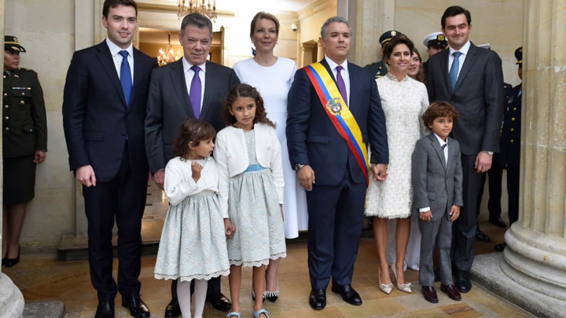 Colombia's new President Iván Duque, and his family, are phographed with former president Juan Manuel Santos and his family upon arrival at the presidential palace in Bogotá on Tuesday.