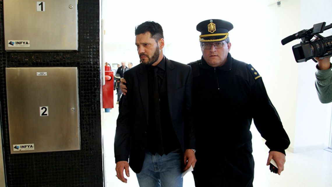 Matias Messi is escort outside the Criminal Justice Center in Rosario, Argentina Thursday, August 16, 2018.