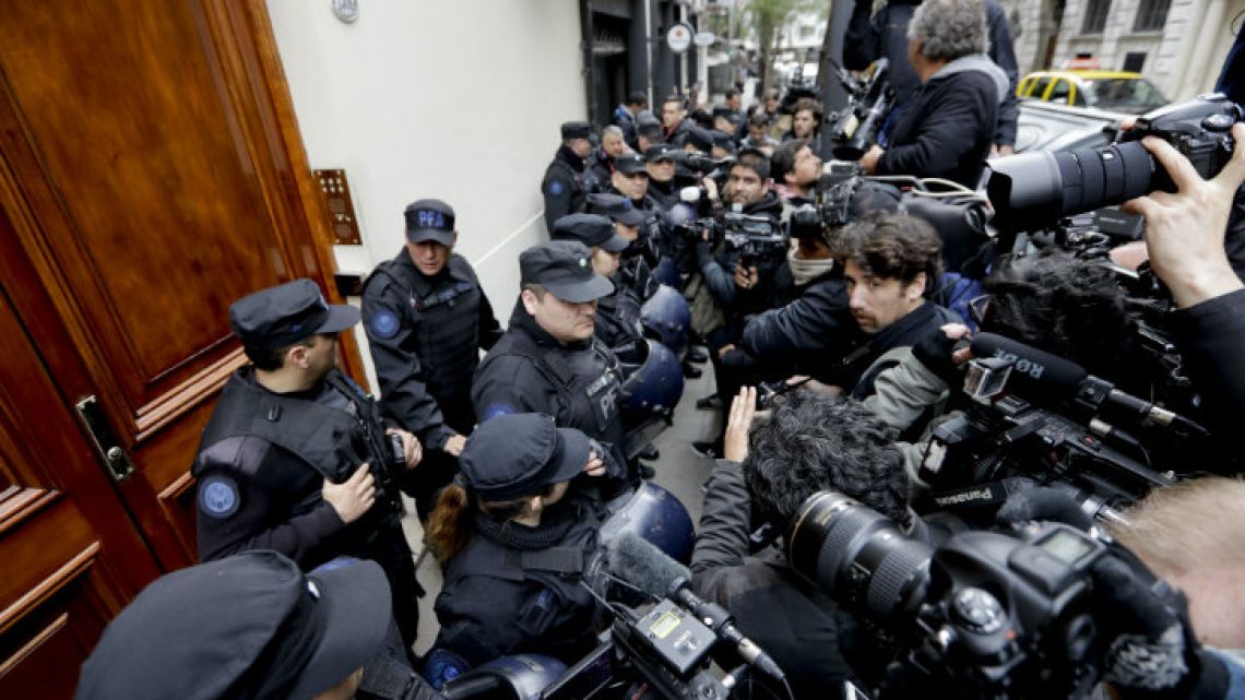 Police keep the press at bay as they search the home of Cristina Fernández de Kirchner, in Recoleta.