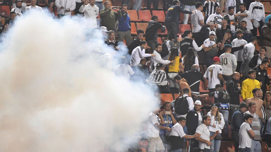 Angry fans of Brazil's Santos are seen on the stands as riot police are deployed during the Copa Libertadores football match against Argentina's Independiente Pacaembu Stadium in Sao Paulo, Brazil, on August 28, 2018. The match was suspended in the 81st minute after fans of Santos threw bangers onto the field and the police was deployed to provide security. South America's governing body Conmebol awarded the first leg clash between the teams to Independiente with a 3-0 score just hours before today's match because Santos fielded and ineligible player.