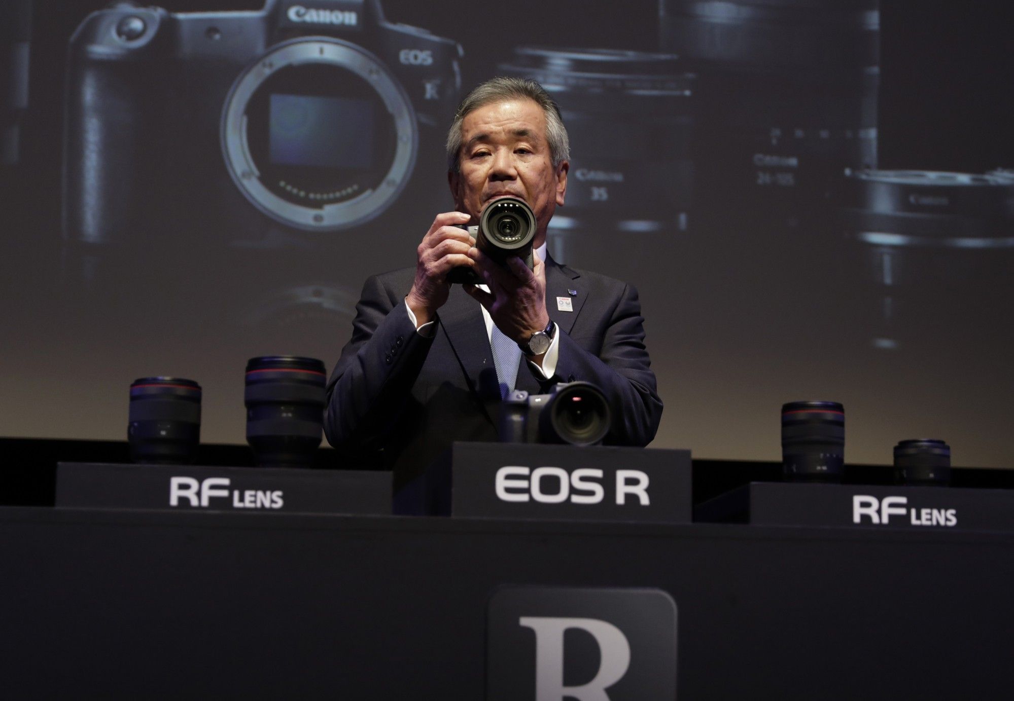 Masaya Maeda holds a Canon EOS R during an event in Tokyo