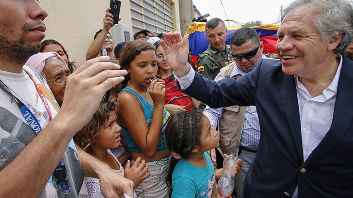 The Secretary-General of the Organisation of American States (OAS), Luis Almagro (right), greets Venezuelans during his visit to the Divina Providencia migrant shelter in Cúcuta, Colombia.