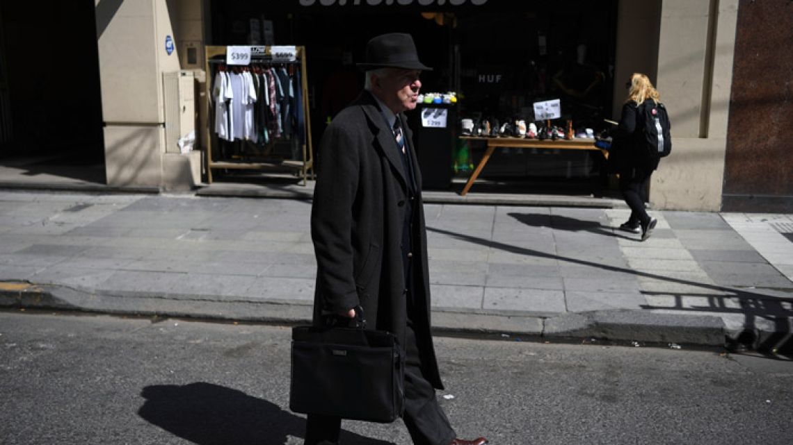 A man walks along the street in downtown Buenos Aires.