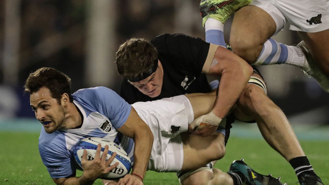 Argentina's Los Pumas fly-half Nicolás Sánchez (left) vies for the ball with New Zealand's All Blacks lock Scott Barrett, during their Rugby Championship match at José Amalfitani stadium in Buenos Aires.  