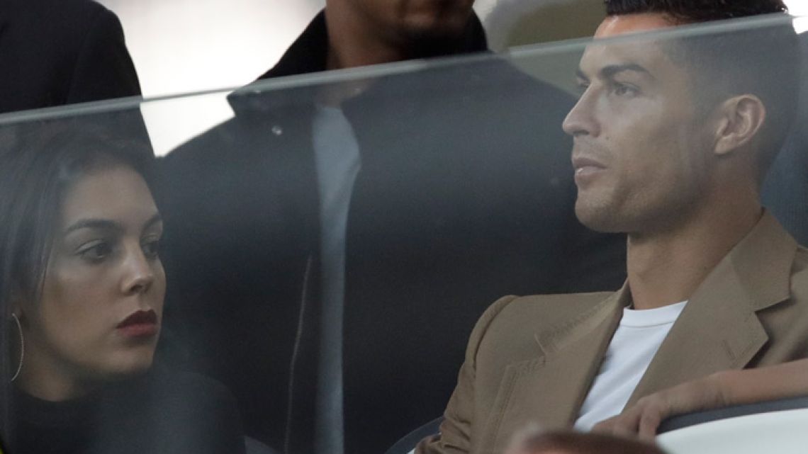 Juventus forward Cristiano Ronaldo and his partner Georgina sit in the stands prior to the Champions League, group H soccer match between Juventus and Young Boys, at the Allianz stadium in Turin, Italy, Tuesday, October 2, 2018. 
