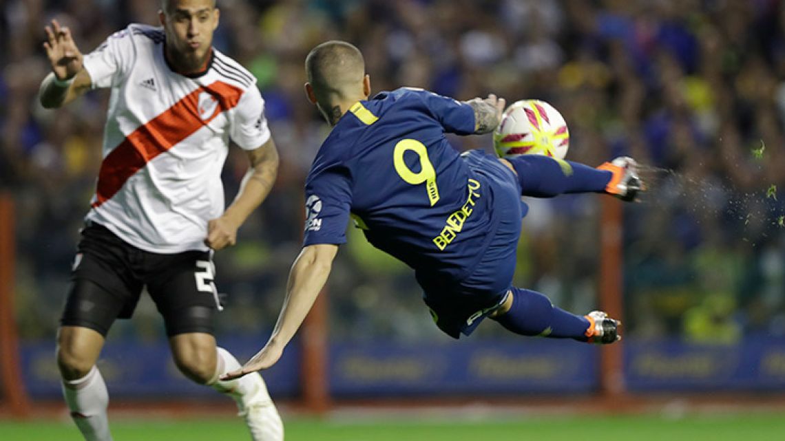 Dario Benedetto of Boca Juniors, right, strikes the ball as defender Jonatan Maidana of River Plate attempts to block him during the Superclásico clash back in September.