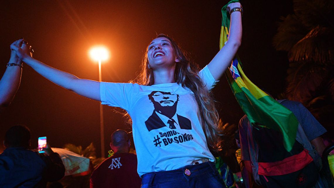 A supporter of presidential candidate for the Social Liberal Party (PSL) Jair Bolsonaro, Soraya Nardelli, 23, celebrates outside of the residential condominium where he lives after the first round of general elections, in Barra da Tijuca, in Rio de Janeiro, Brazil.