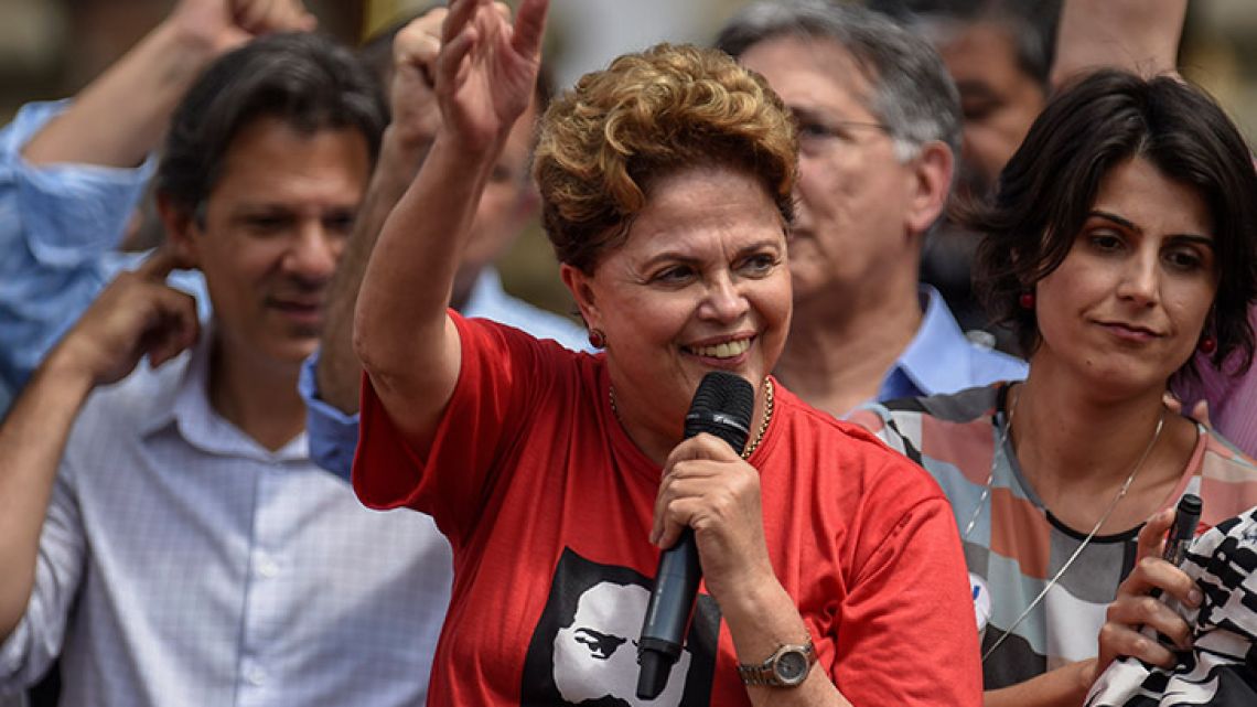 In this file photo taken on September 21, 2018, former Brazilian President and candidate for the Senate of Minas Gerais of Brazil's Workers' Party (PT), Dilma Rousseff (center), speaking to supporters during a campaign rally.