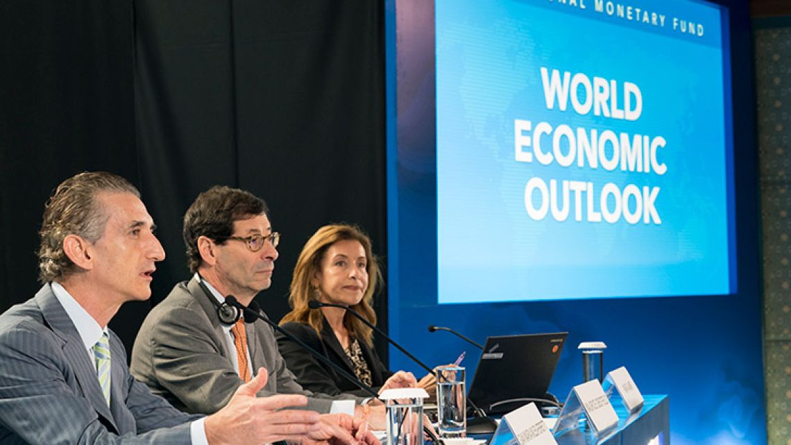 This handout photo taken and released by the International Monetary Fund on October 9, 2018 shows IMF Economic Counsellor Maurice Obstfeld (centre), deputy director Gian Maria Milesi-Ferretti (left) and communications officer Wafa Amr (right) answering questions during the World Economic Outlook press conference.