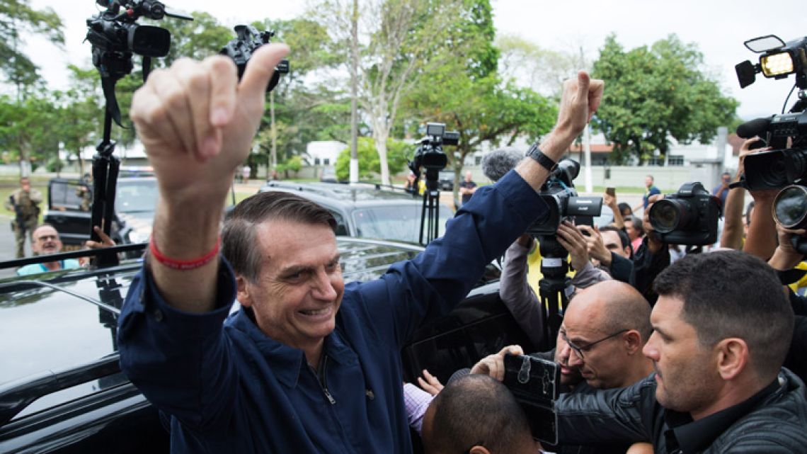 Brazil's right-wing presidential candidate for the Social Liberal Party (PSL) Jair Bolsonaro gives his thumbs up after casting his vote at Villa Militar, during general elections, in Rio de Janeiro, Brazil, on October 7, 2018.  