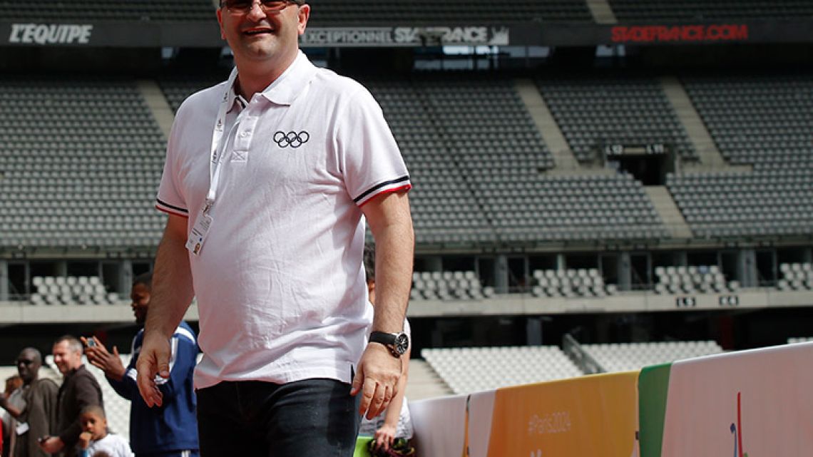 In this Monday May 15, 2017 file photo, International Olympic Committee Evaluation Commission Chair Patrick Baumann smiles as he visits the Stade de France stadium, in Saint-Denis, outside Paris. Patrick Baumann, the CEO-like secretary general of basketball’s world governing body who was seen as a potential IOC president, has died at the Youth Olympics it was announced on Sunday, Oct, 14 2018. He was 51. The International Basketball Federation says Baumann “unexpectedly succumbed to a heart attack” in Buenos Aires. 