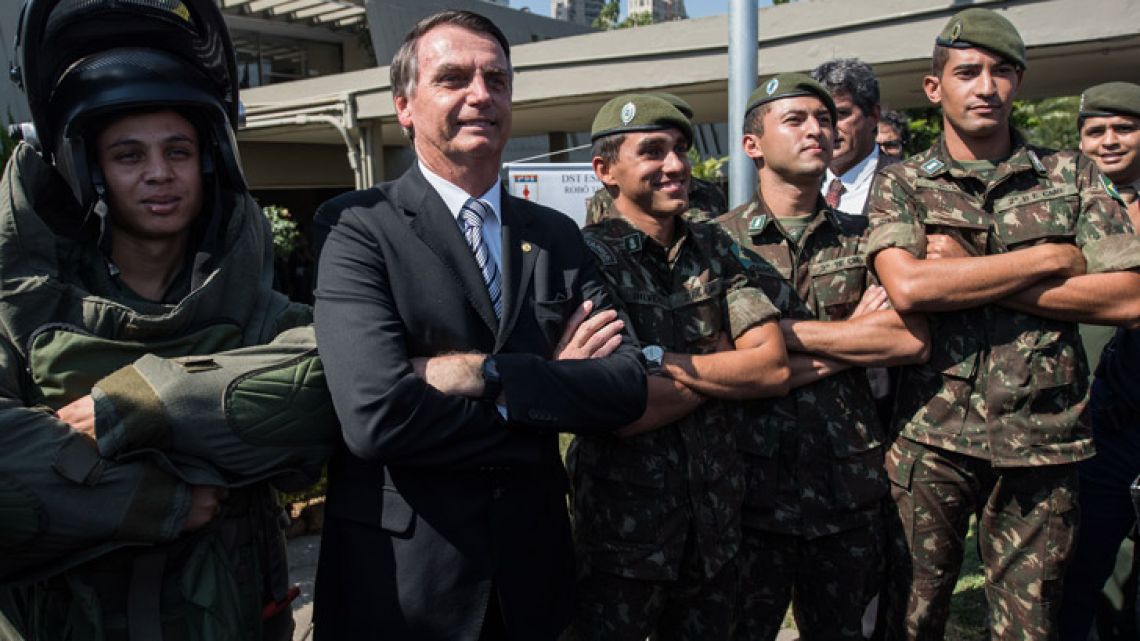 Presidential candidate Jair Bolsonaro poses for pictures with militaries during an military event in Sao Paulo, Brazil.