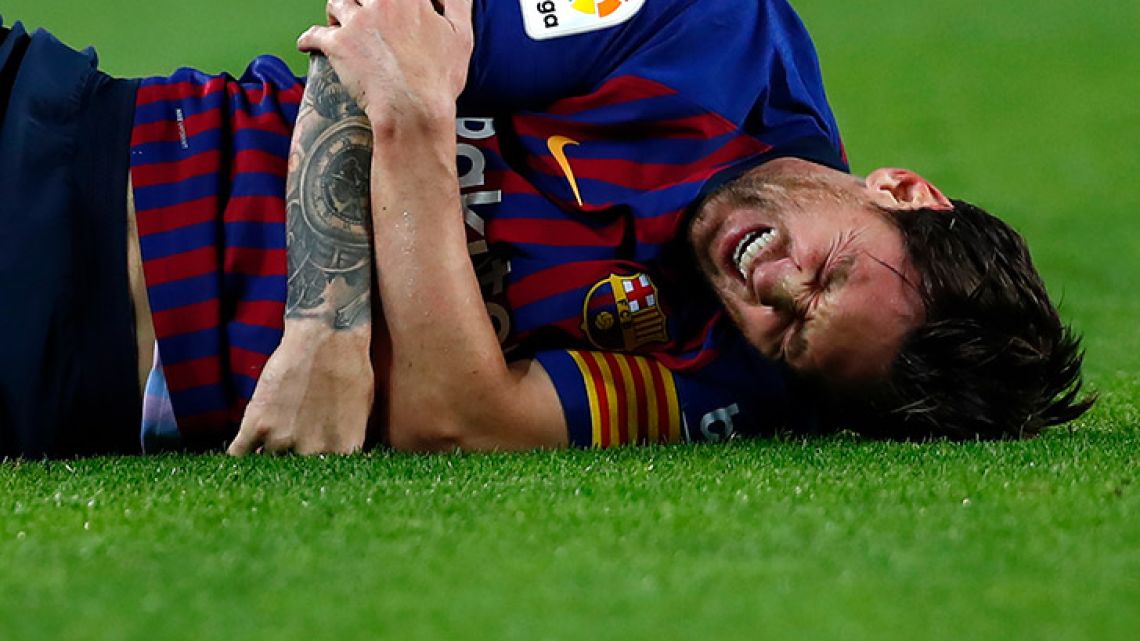 FC Barcelona's Lionel Messi is injured during the Spanish La Liga match between FC Barcelona and Sevilla at the Camp Nou stadium, Saturday, October 20, 2018. 