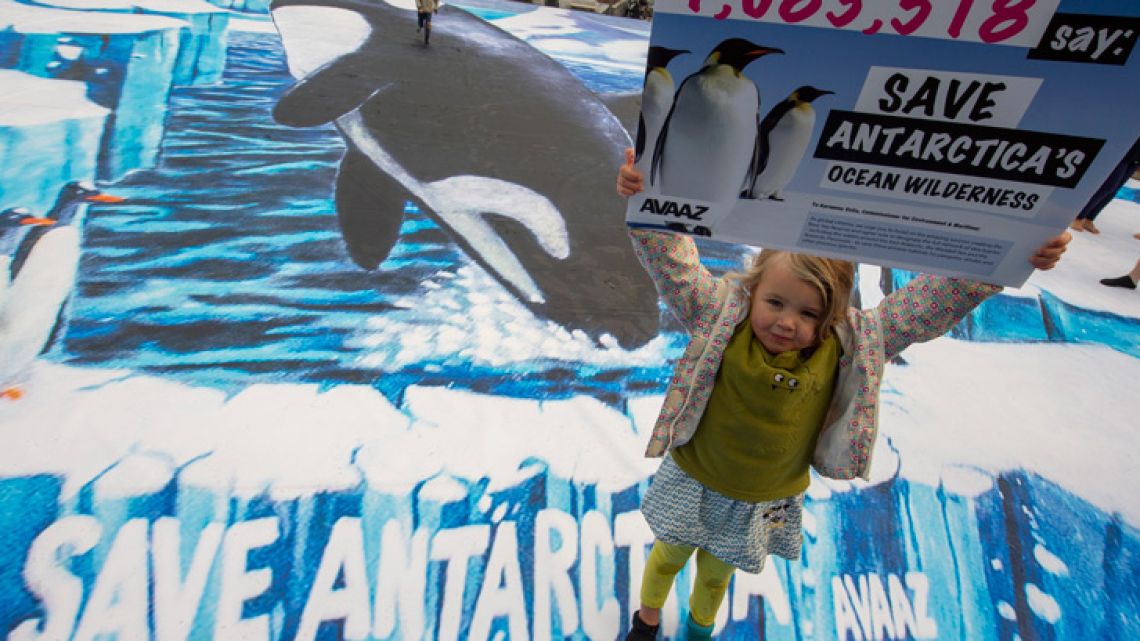 A girl holds up a placard highlighting a petition from AVAAZ with one million signatures calling for a new marine reserve in the Antarctic.