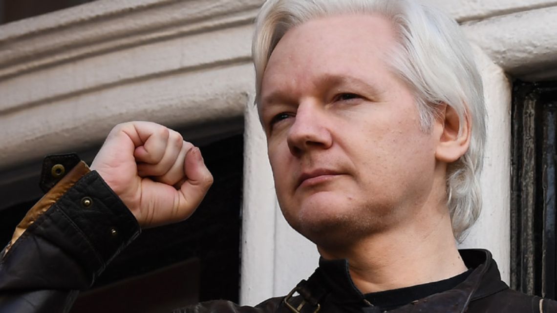 Wikileaks founder Julian Assange raises his fist prior to addressing the media on the balcony of the Embassy of Ecuador in London on May 19, 2017.