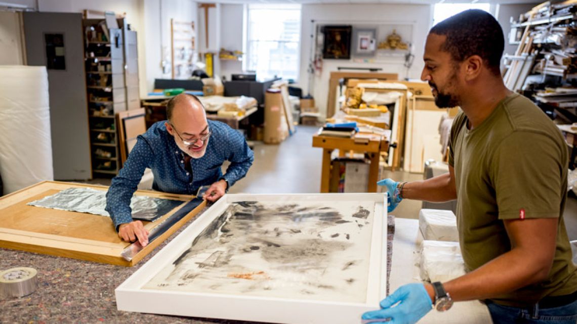 Government Art Collection staff members aclimatise paintings before they are shipped to British embassy buildings in tropical climates at Government Art Collection in central London