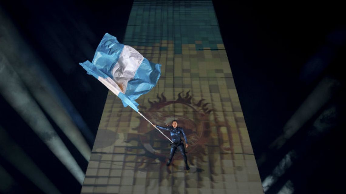 The national flag is walked down the Obelisk during the Youth Olympic Games Opening Ceremony.