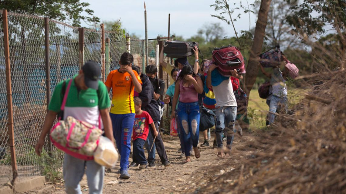 Venezuelans illegally crossing into Colombia along a path known as a 