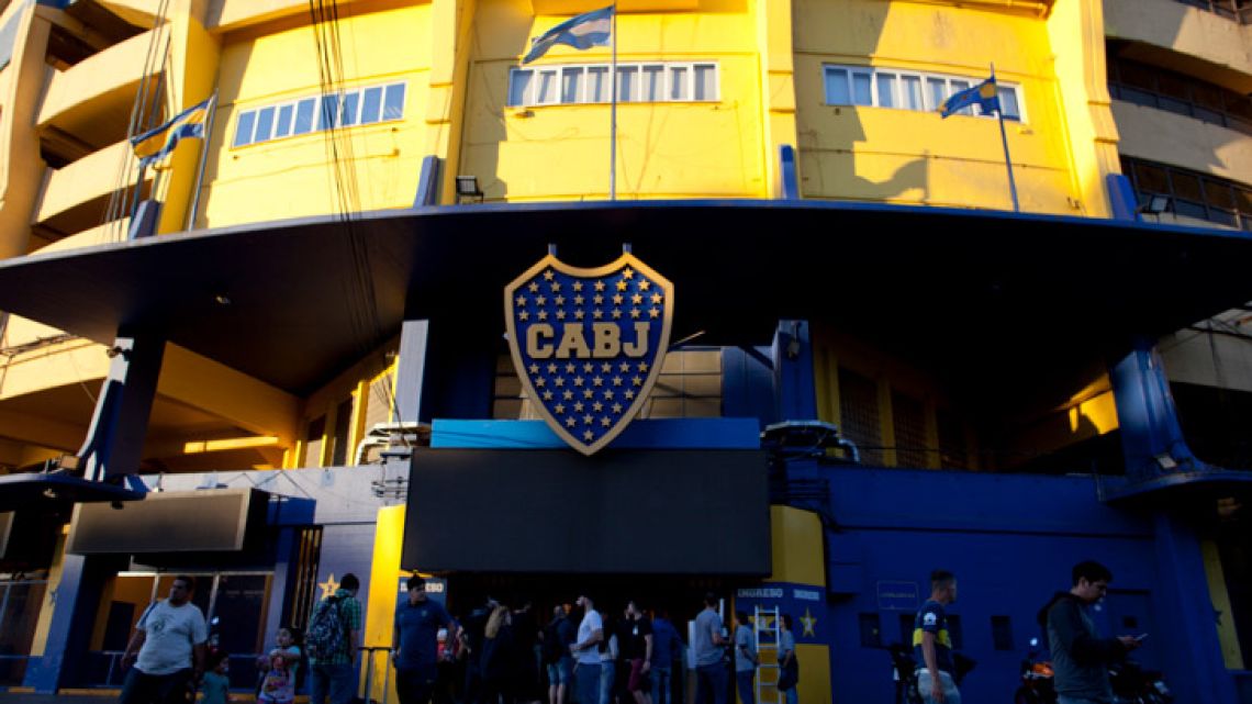 People stand outside Boca Juniors stadium in Buenos Aires, Argentina Wednesday, Nov. 7, 2018.