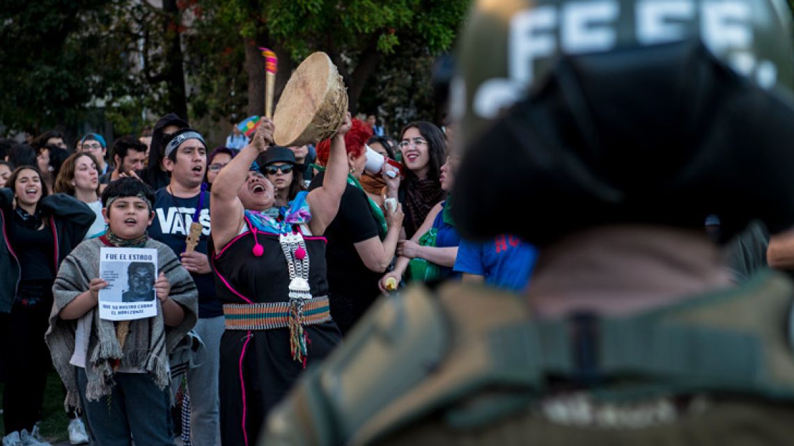 Students and Mapuche activists protest in Santiago, demanding the resignation of Chile's Interior Minister Andres Chadwick, following the death of a young Mapuche man during a police operation.