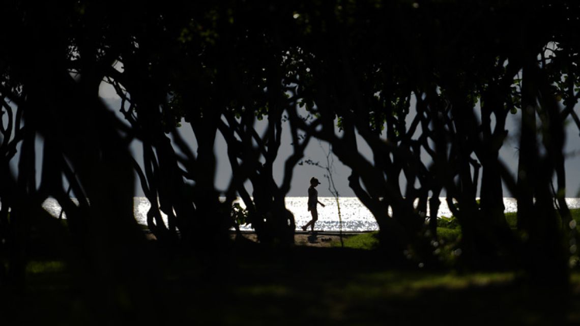 A woman walks at a park in Rio de Janeiro, Brazil.  