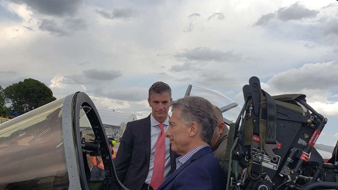 President Mauricio Macri sits inside an Argentine-made IA 63 Pampa III jet fighter.
