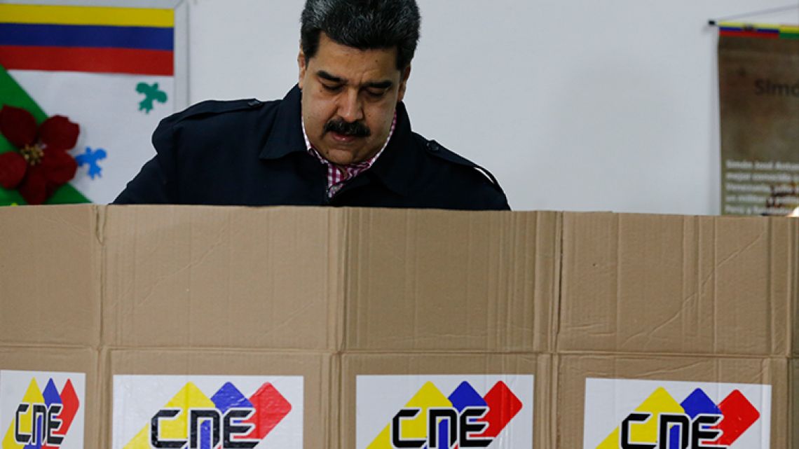 Venezuela's President Nicolas Maduro votes during local elections in Caracas, Venezuela, on Sunday, December 9, 2018.