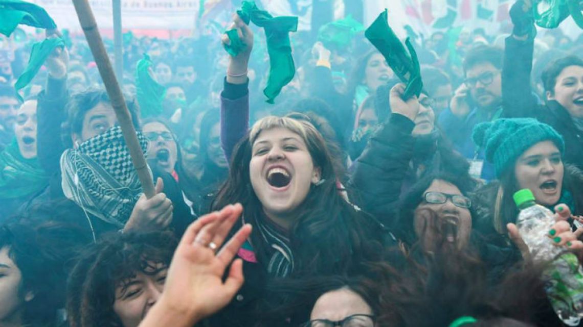 Hundreds of thousands of green pro-choice activists burst into cheers and tears on the streets outside Congress. 