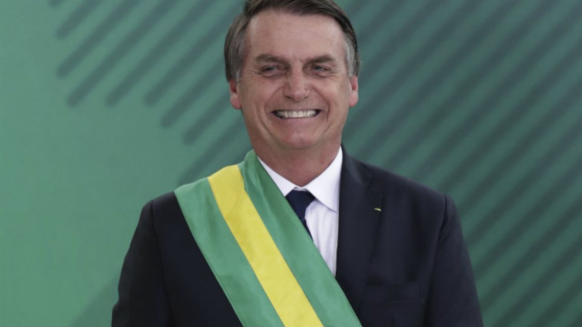 Brazil’s President Jair Bolsonaro smiles during a Cabinet meeing in Brasilia.