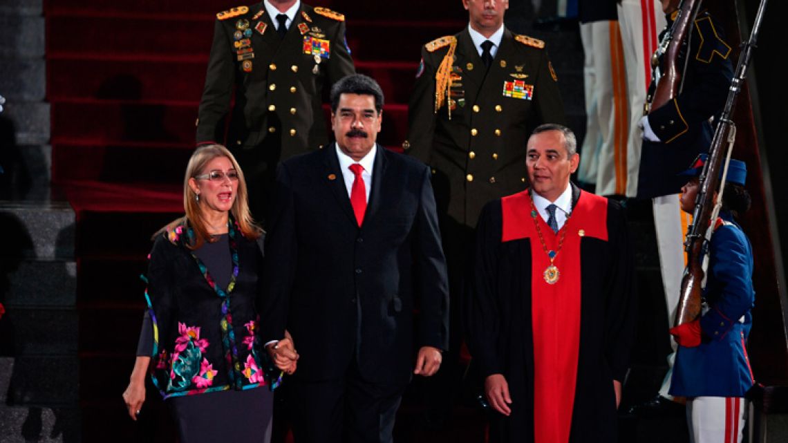 Venezuela's President Nicolás Maduro (centre) walks flanked by First Lady Cilia Flores and the president of the Supreme Court of Justice (TSJ) Maikel Moreno (right) upon arrival for the inauguration ceremony of his second mandate, at the TSJ headquarters in Caracas.