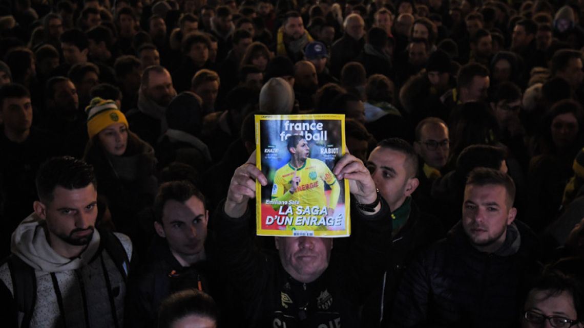 Supporters gather in Nantes after it was announced that the plane Emiliano Sala was flying on vanished during a flight from Nantes in western France to Cardiff in Wales, on January 22, 2019. The 28-year-old Argentine striker is one of two people still missing after contact was lost with the light aircraft he was travelling in on January 21, 2019 night. Sala was on his way to the Welsh capital to train with his new teammates for the first time after completing a £15 million (US$19 million) move to Cardiff City from French side Nantes on January 19. LOIC VENANCE / AFP