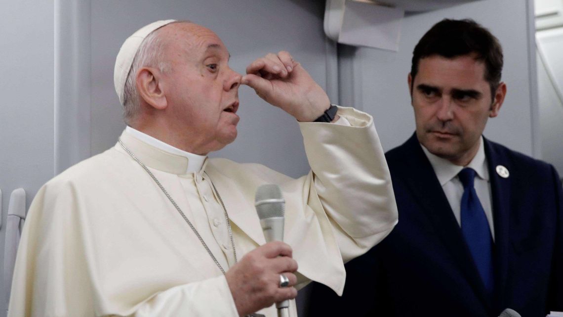 Pope Francis gestures to describe snobbish, hypocritical Catholics as he answers reporters' questions aboard the papal plane after taking off from Panama City. 