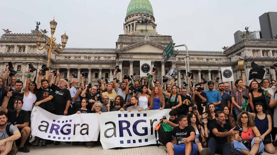 A group of photographers protest police violence outside Argentina's Congress.